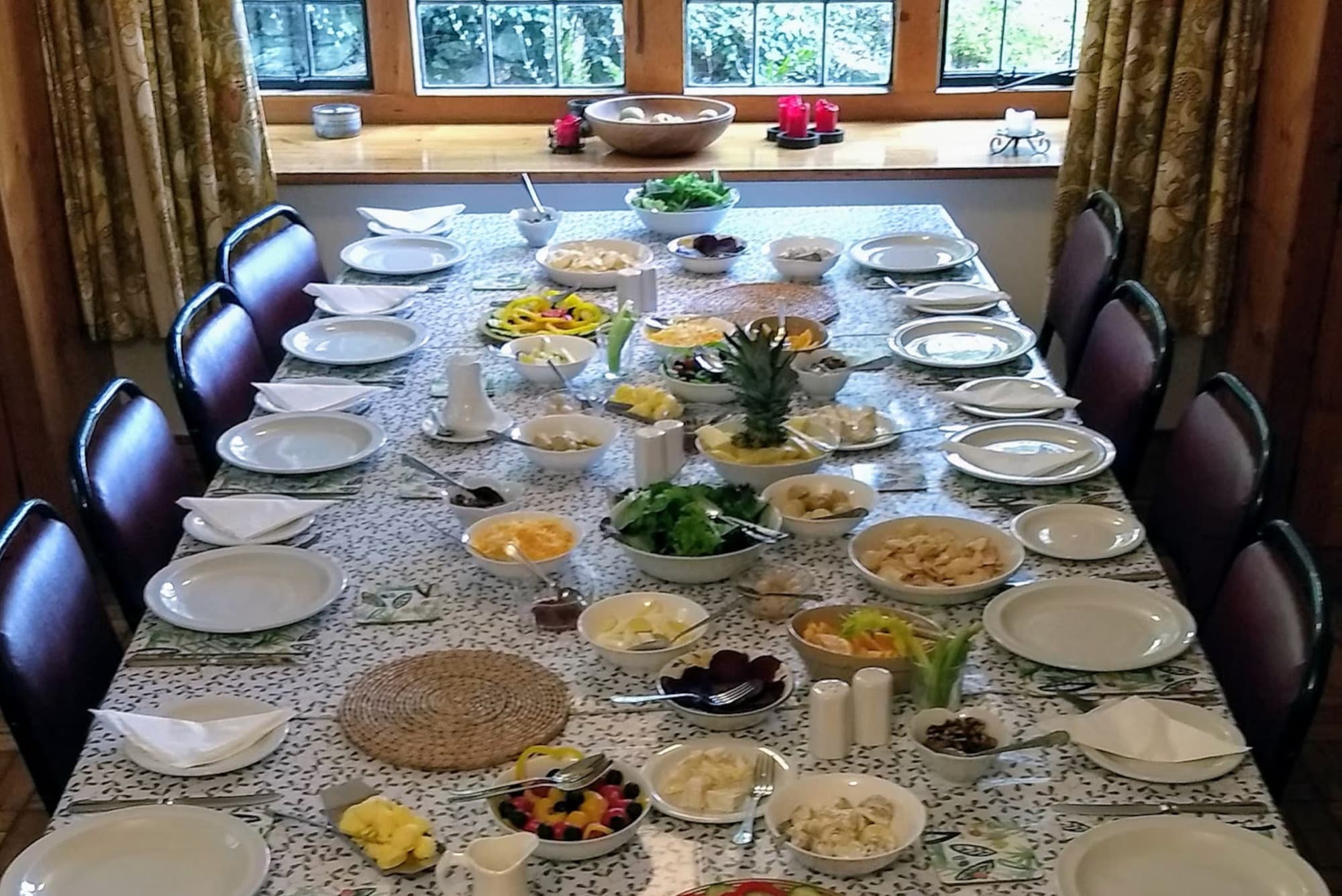 A long dining table laid with a vegetarian spread